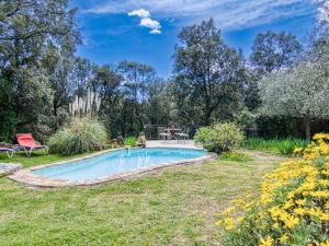 a swimming pool in a yard with a bench at Holiday Home Chez Canard by Interhome in Ampus