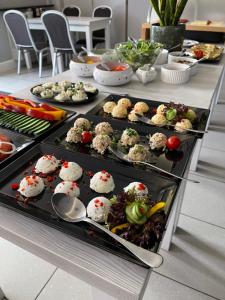 a buffet line with many different types of food at Villa Garden in Oleśnica