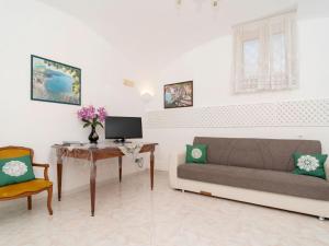 a living room with a couch and a table at Apartment Limoneto a Priora by Interhome in Massa Lubrense