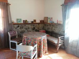 a table and chairs in a room with a table and chairs at Casas Rurales La Trufa Madre Casa 2 in Vega del Codorno +9 photos