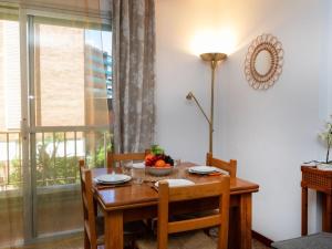 a dining room table with a bowl of fruit on it at Apartment Las Americas by Interhome in Lloret de Mar +14 photos