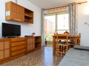 a living room with a television and a dining room table at Apartment Las Americas by Interhome in Lloret de Mar