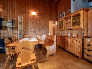 a wooden dining room with a table and chairs at Apartment Marguerettaz-2 by Interhome in Sarre