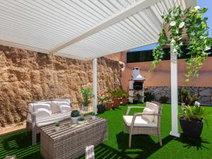 a patio with chairs and a table and a grill at Holiday Home Emballia by Interhome in Caulés