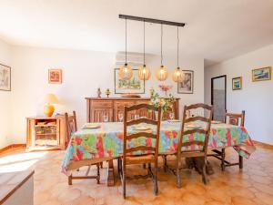 a dining room with a table and chairs at Holiday Home Le Mas d'Olive - GRI230 by Interhome in Grimaud
