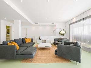 a living room with two couches and a table at Villa Megin by Interhome in Cumbre del Sol