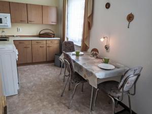 a kitchen with a table and chairs in a room at Holiday Home Zerna by Interhome in Bad Muskau