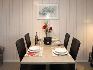 a dining room table with chairs and a table with wine glasses at Apartment Arlette Nr- 34 by Interhome in Gstaad