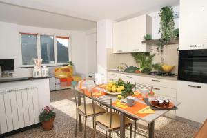 a kitchen with a table with fruit on it at CASA ALESSIA NEL VERDE con WI-FI in Ageno