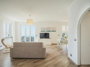 a living room with a couch and a table at Holiday Home Sorvegallo by Interhome in Moneglia +30 photos