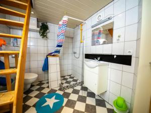 a small bathroom with a checkered floor at Apartment Haus Keller by Interhome in Heppingsen