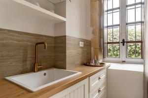 a kitchen with a sink and a window at Lithinon Luxury Suites with Free Parking in Chania Town +79 photos
