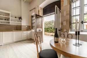 a kitchen with a table and chairs and a window at Lithinon Luxury Suites Old Town Chania free on-site Parking in Chania