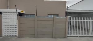 a fence with a gate in front of a building at Lasai Accommodation in Worcester