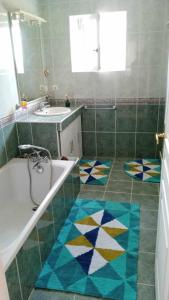 a bathroom with a tub and a sink at Impérial in Puy-lʼÉvêque +24 photos