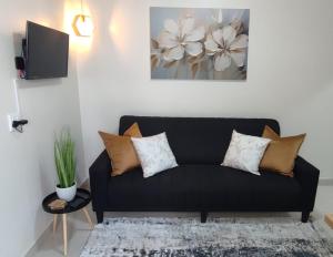 a black couch with pillows in a living room at Lasai Accommodation in Worcester