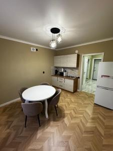 a kitchen with a table and chairs in a room at Квартира посуточно in Kokshetau