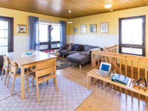 a living room with a table and a couch at Holiday Home Villa-lyydia by Interhome in Niemikylät