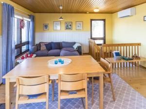 a living room with a table and a couch at Holiday Home Villa-lyydia by Interhome in Niemikylät