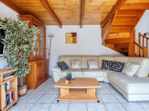 a living room with a couch and a table at Holiday Home Y Sian Ben by Interhome in Lacanau-Océan