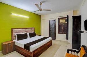 ein Schlafzimmer mit einem Bett mit einer grünen Wand in der Unterkunft Premium stay in Noida