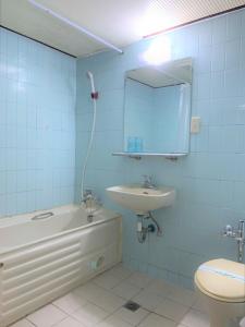 a bathroom with a sink toilet and a mirror at Inn Sun Hotel in Changhua City