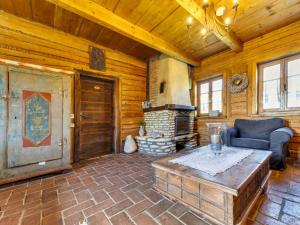 a living room with a fireplace in a log cabin at Holiday Home Jura dla Ciebie by Interhome in Cisowa