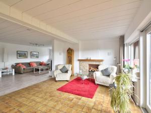 a living room with two chairs and a fireplace at Apartment Waldvogt by Interhome in Lothe