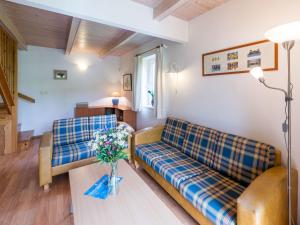 a living room with two couches and a table at Holiday Home Holiday Hill 40 by Interhome in Černý Dŭl