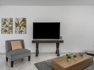 a living room with a tv and a chair at Apartment Marbella Real by Interhome in Marbella