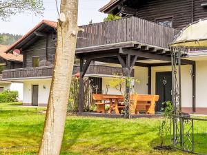 a house with a picnic table in the yard at Apartment Am Hohen Bogen-35 by Interhome in Arrach