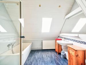 a bathroom with a sink and a tub and a toilet at Apartment Am Brauamt by Interhome in Schieder-Schwalenberg