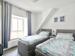 a bedroom with two beds and a window at Apartment Am Brauamt by Interhome in Schieder-Schwalenberg