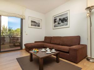 a living room with a couch and a coffee table at Apartment Lloret Garden by Interhome in Lloret de Mar