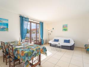 a living room with a table and a bed at Villa Les Pesquiers by Interhome in Hyères +29 photos