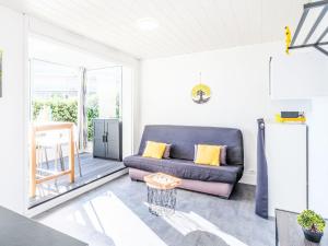 a living room with a couch and a patio at Studio Port Arcachon-2 by Interhome in Arcachon