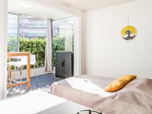 a bedroom with a bed and a large window at Studio Port Arcachon-2 by Interhome in Arcachon