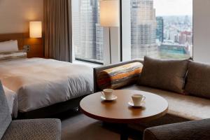 a hotel room with a bed and a coffee table at Keio Plaza Hotel Tokyo in Tokyo