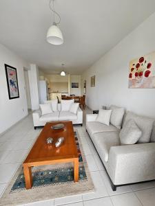 a living room with two couches and a coffee table at Iris Village in Paphos