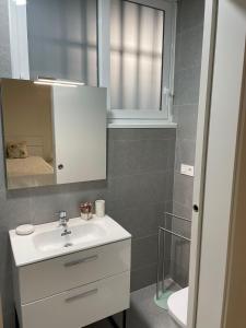 a bathroom with a sink and a mirror at Exyca Tetuán in Madrid