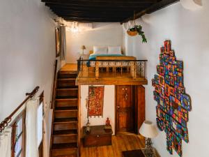 a bedroom with a bed and a staircase in a room at Casa Aletta - Old Town Apt. in Rhodes Town