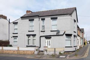 a white house on the side of a street at 4 bed house parking Wi-Fi garden in Wallasey