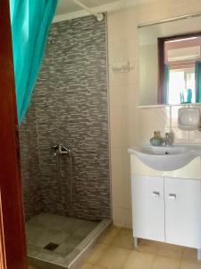 a bathroom with a shower and a sink at Eleni in Kissamos