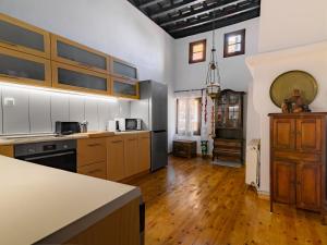 a large kitchen with wooden floors and wooden cabinets at Casa Aletta - Old Town Apt. in Rhodes Town