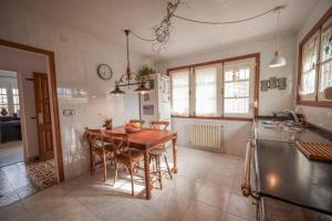 a kitchen with a wooden table and chairs in it at Maria La Franca in La Franca