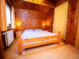 a bedroom with a bed in a wooden cabin at Chalet Geli by Interhome in Bad Arolsen