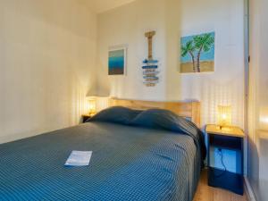 a bedroom with a bed and two night stands with lamps at Apartment Les Terrasses de l'Atlantique-7 by Interhome in Lacanau-Océan
