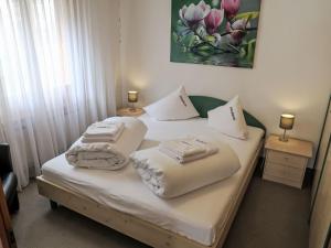 a bedroom with two beds with towels on them at Apartment Utoring Acletta-1 by Interhome in Disentis