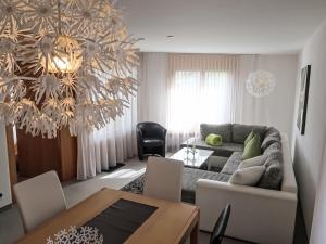 a living room with a couch and a table at Apartment Utoring Acletta-1 by Interhome in Disentis