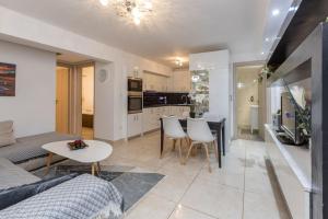 a living room and kitchen with a couch and a table at Varkiza Seaside 2BD Apartment in Varkiza